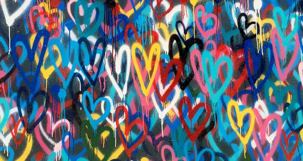 Public wall art. Many hearts in many colors. Spray painted.