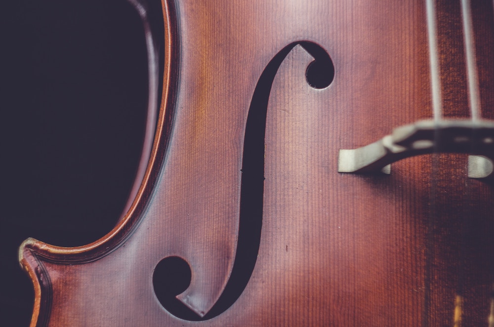 Picture of one f-hole in a stringed instrument, likely a cello.