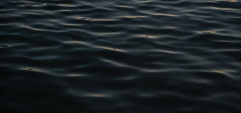 Water rippling gently in minimal light.