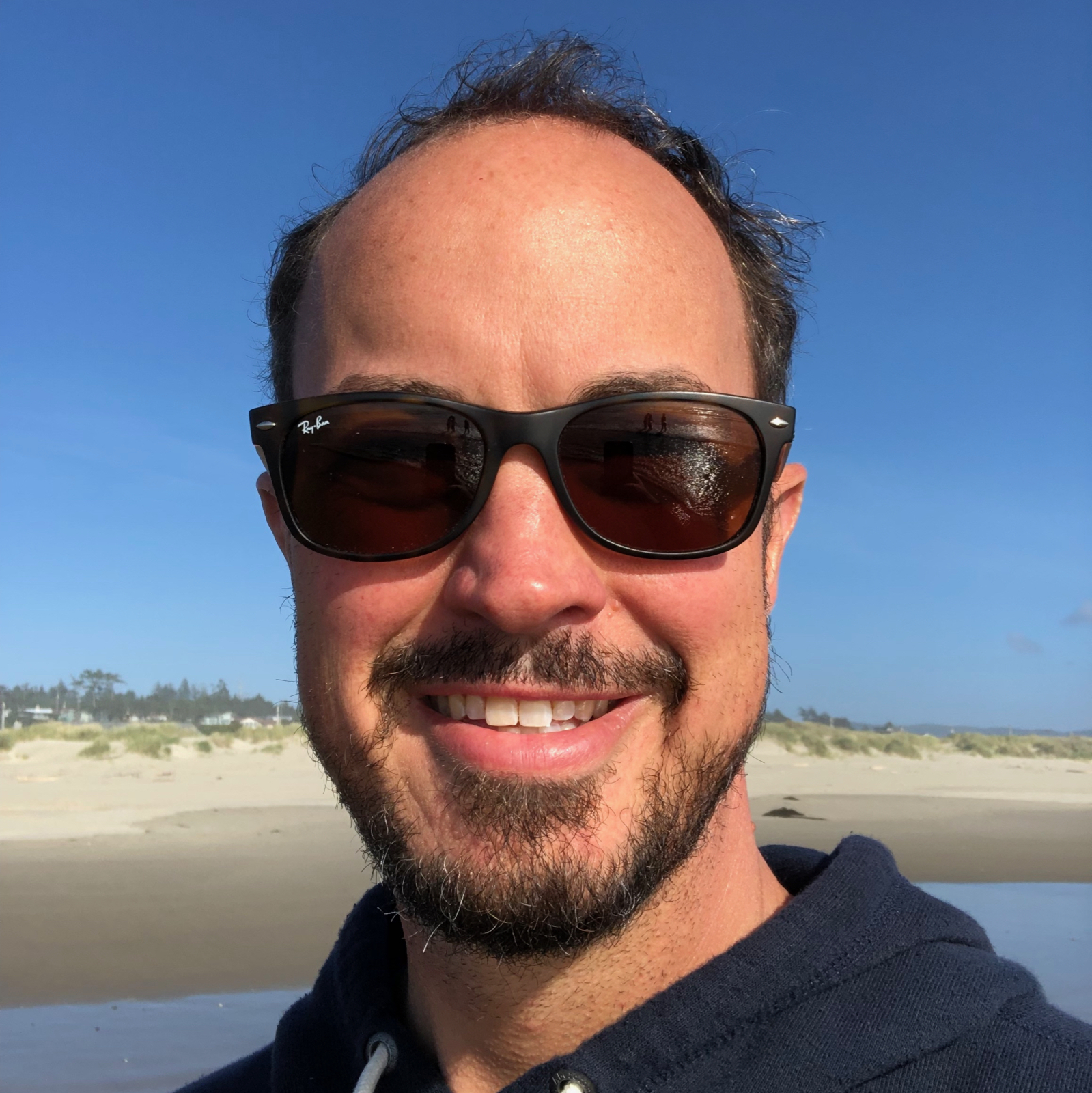 Bearded male with sunglasses at a beach